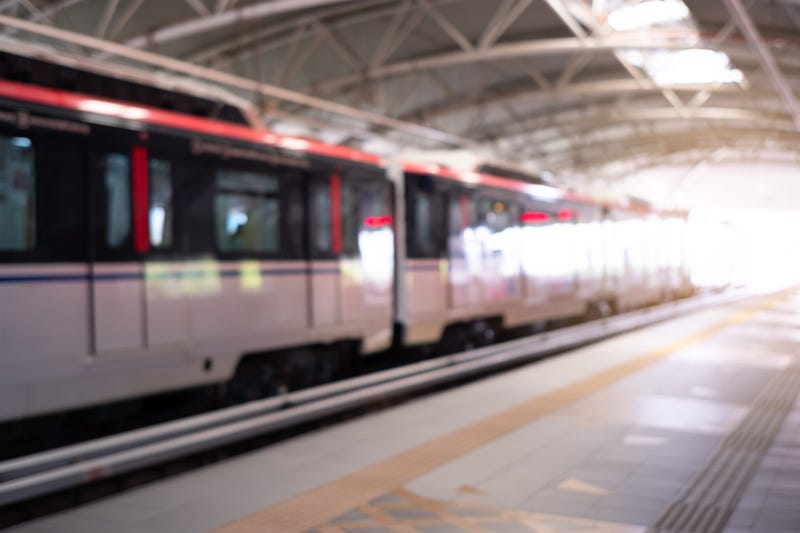 A light rail train pulling into a station