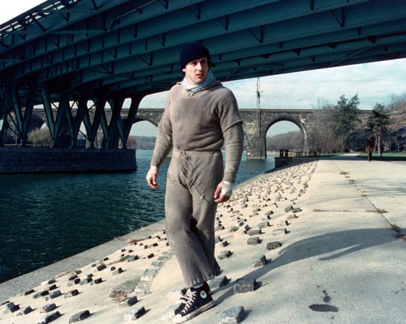 Sylvester Stallone as Rocky Balboa standing by the Schuylkill River in Fairmount Park.