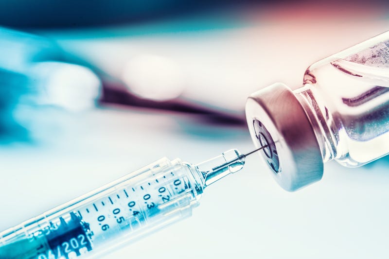 Photo of a vaccine vial with needle