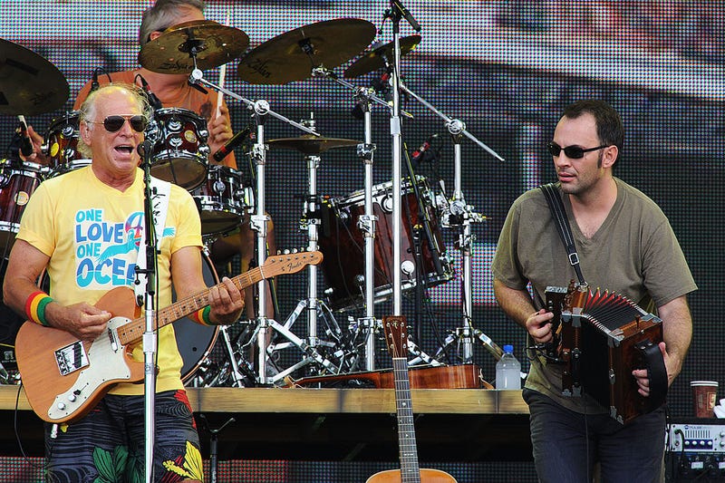 Musician Jimmy Buffett (L) performs onstage at Jimmy Buffett & Friends: Live from the Gulf Coast, a concert presented by CMT at on the beach on July 11, 2010 in Gulf Shores, Alabama.