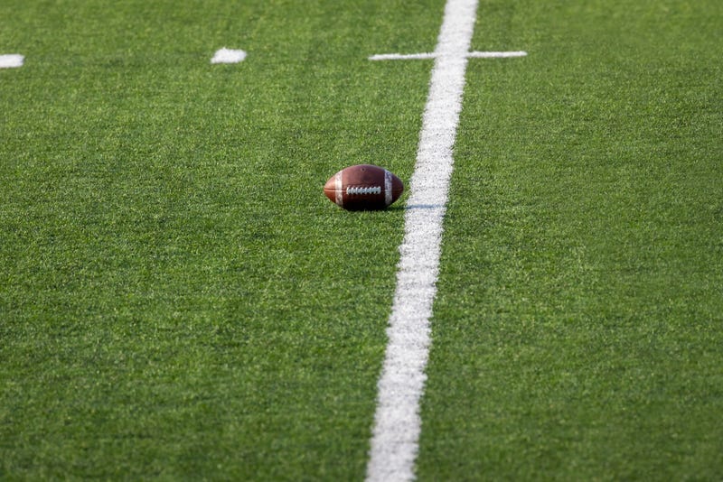 Football set on field ready for the next play. 