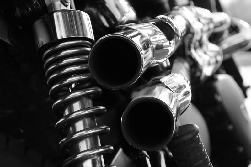 monochrome close up rear view of a powerful classic black vintage motorcycle