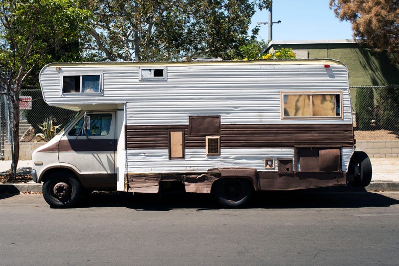 A side view of a vintage RV Van in the street