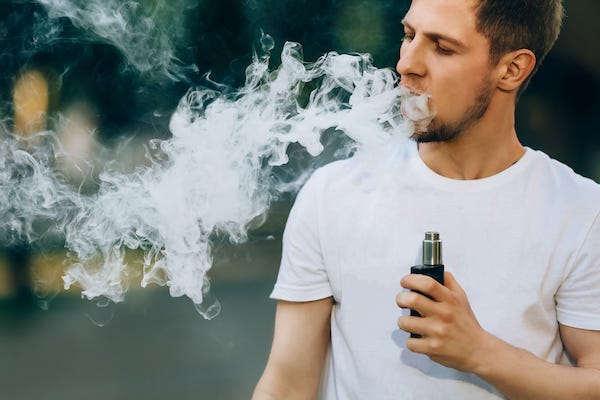 Man vaping outdoors