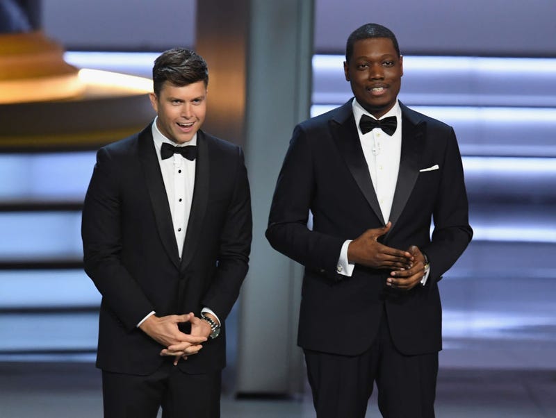 Colin Jost (L) and Michael Che speak onstage during the 70th Emmy Awards at Microsoft Theater on September 17, 2018 in Los Angeles, California.