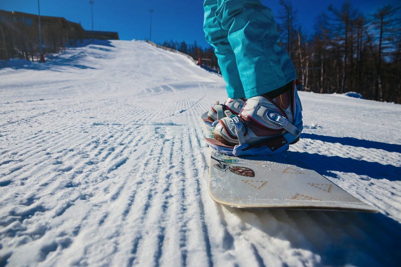 women's boots and snowboard snowboarder in the snow on the mountain