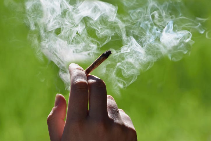 Marijuana joint in someones hand. 