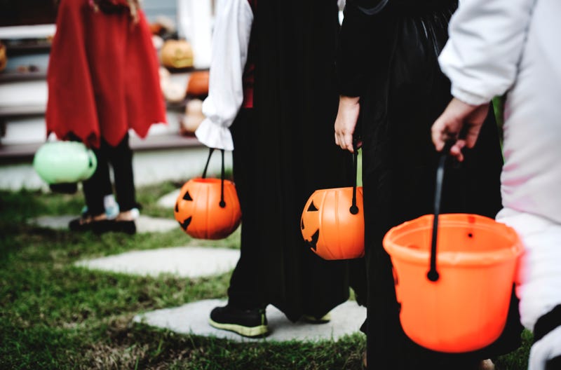 Trick or treaters approaching a house