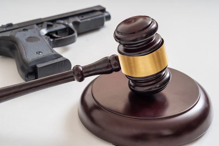 gavel and a gun in a stock image