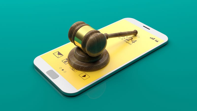 Judge gavel on a smartphone on green background. 3d illustration