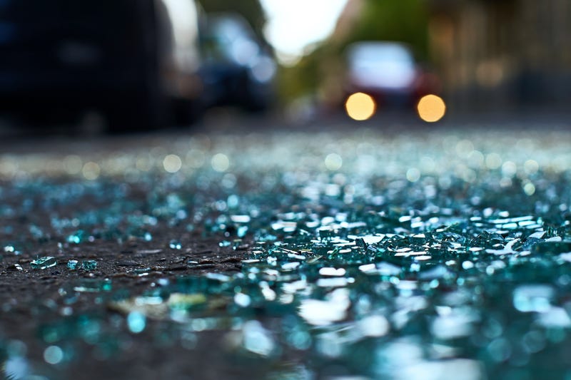 Sharp shards of car glass on the asphalt
