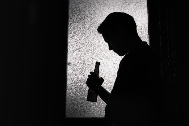 Silhouette of man drinking beer stock photo. 