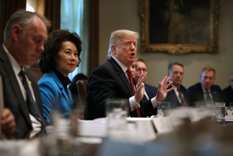 U.S. President Donald Trump (C) talks to reporters during a cabinet meeting with (L-R) Interior Secretary Ryan Zinke, Transportation Secretary Elaine Chao and others in the Cabinet Room at the White House October 17, 2018 in Washington, DC.