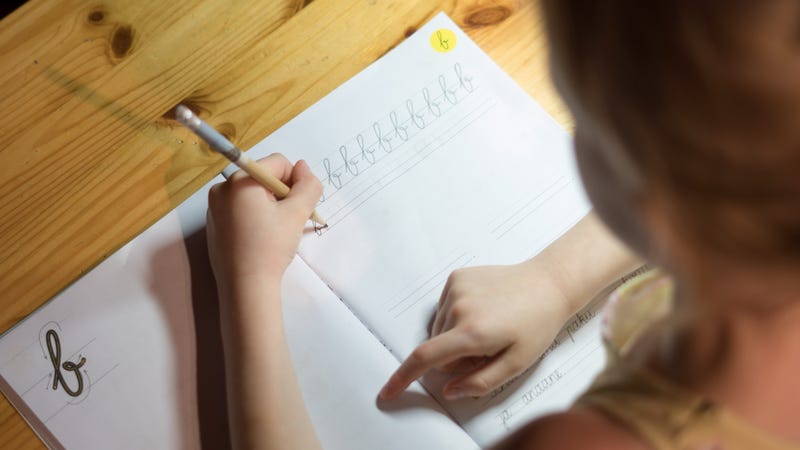 girl practices cursive handwriting 
