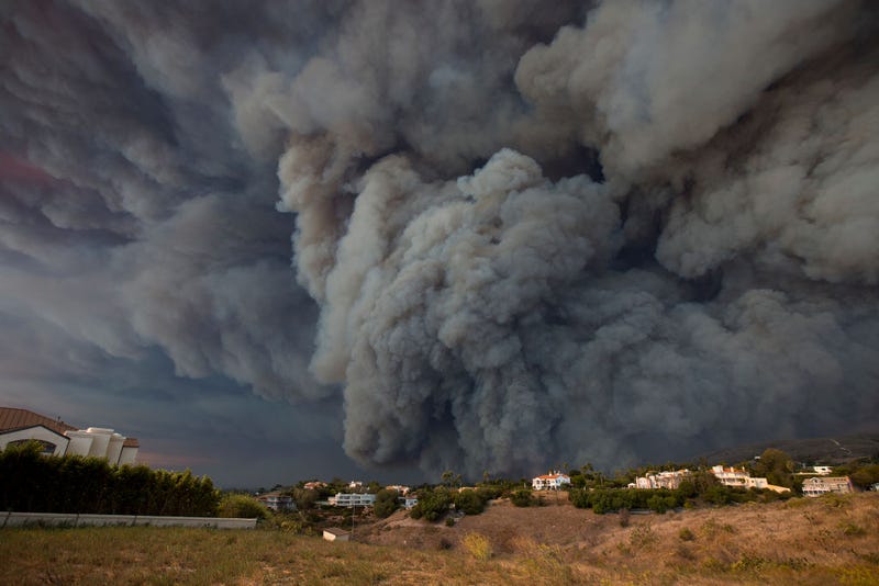 A massive smoke plume, powered by strong winds, rises above the the Woolsey Fire on November 9, 2018 in Malibu, California.