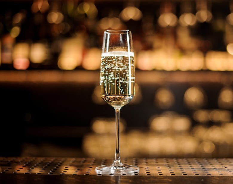 Glass of Champagne standing on a bar counter