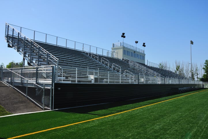 stock image of bleachers at a high school football field.