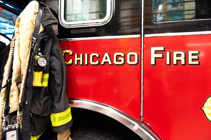 CHICAGO, ILLINOIS, USA - OCTOBER 10, 2018: The fireman's clothes by the real squad fire truck in Chicago Fire Department at the quarters of Engine Co. 5. The legendary series 'Chicago Fire' reportage