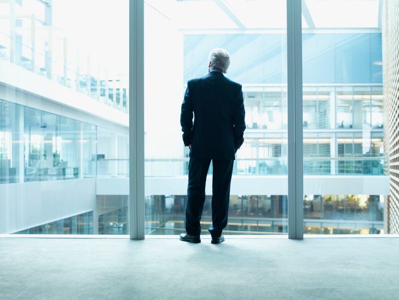 Business man looks out the window. 