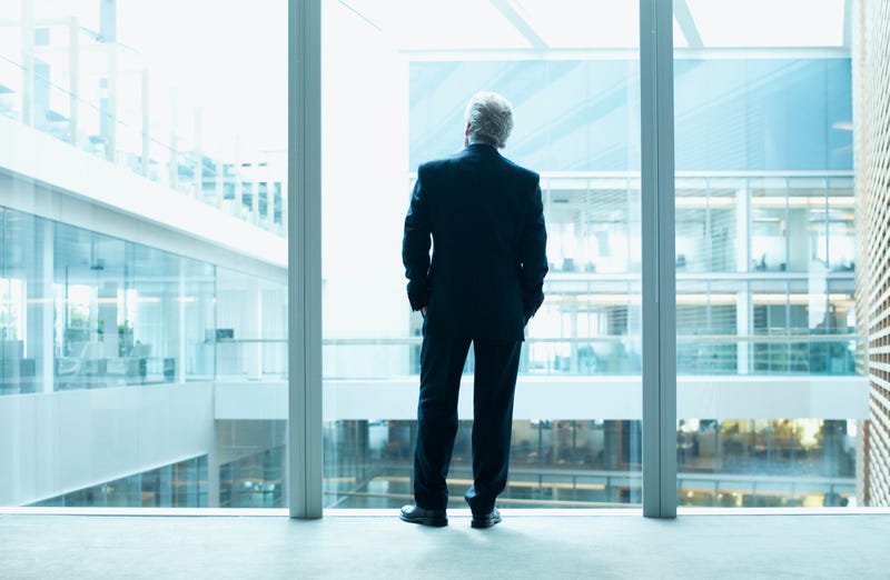 Business man looks out the window.