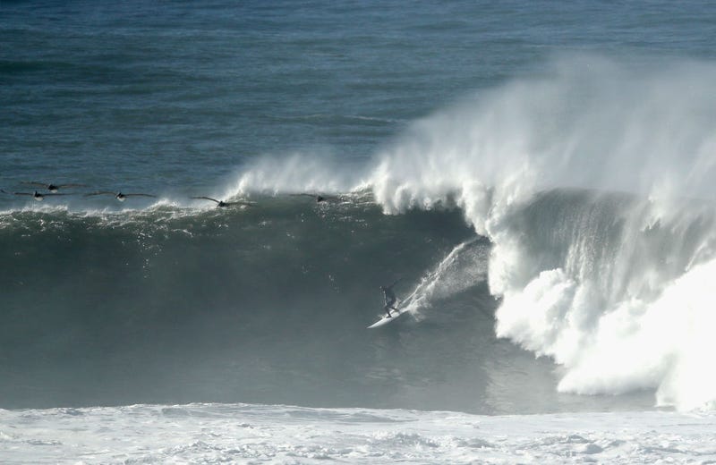 A surfer rides a wave at Mavericks on December 17, 2018 in Half Moon Bay, California.