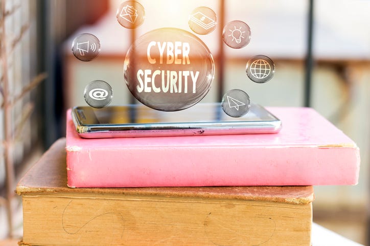 Cyber security concept in transparent bubbles with black phone above book