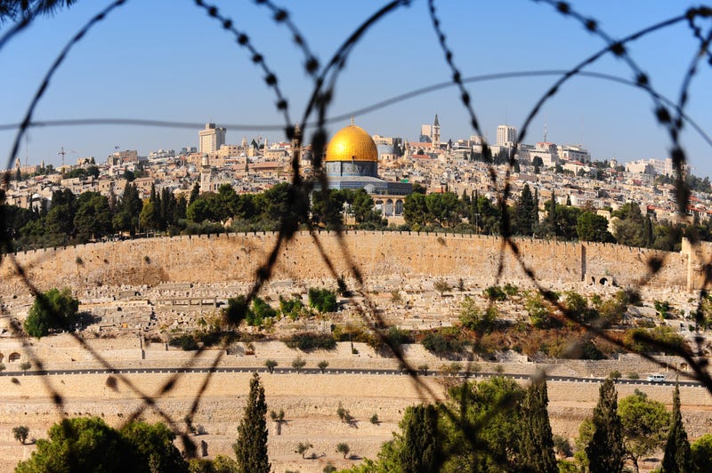 View of the dome of the rock from the Mount of Olives through barbed wire.