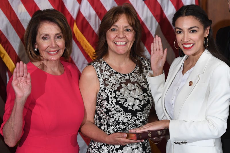 Speaker of the House Nancy Pelosi (L) performs a ceremonial swearing-in for US House Representative Alexandria Ocasio-Cortez (R), D-NY.