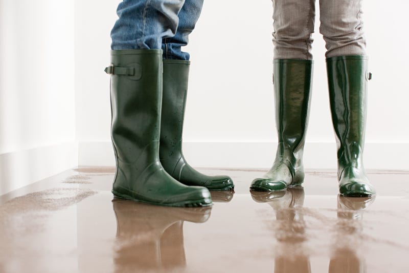Close up of man and woman's boots on flooded floor