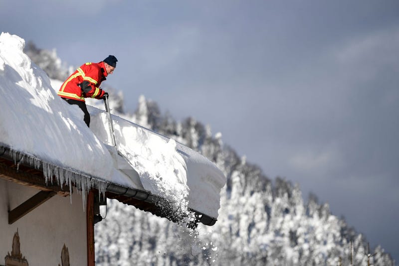 A fireman clears a roof following heavy snowfall in the area on January 12, 2019 in Kruen, Germany. 