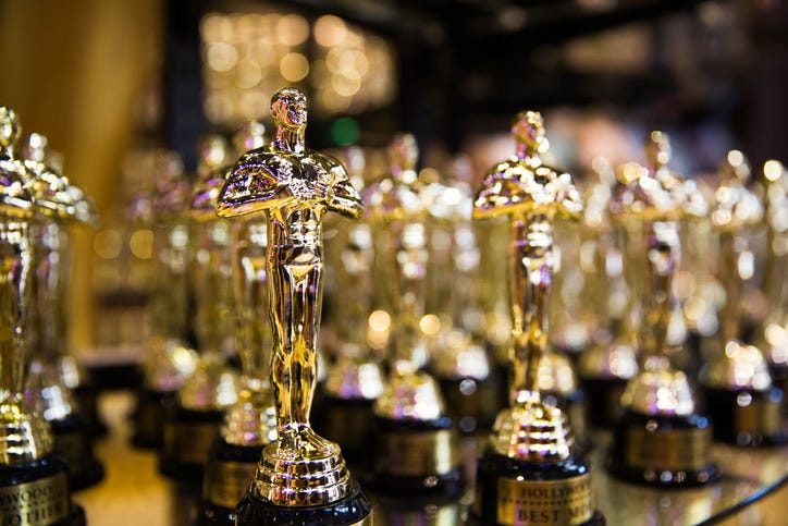 A row Academy Award statuettes 