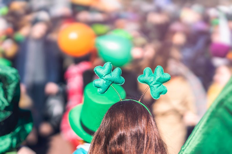Clover head decoration on head of girl close-up. Saint Patrick day, parade in the city, selectriv focus - stock photo
