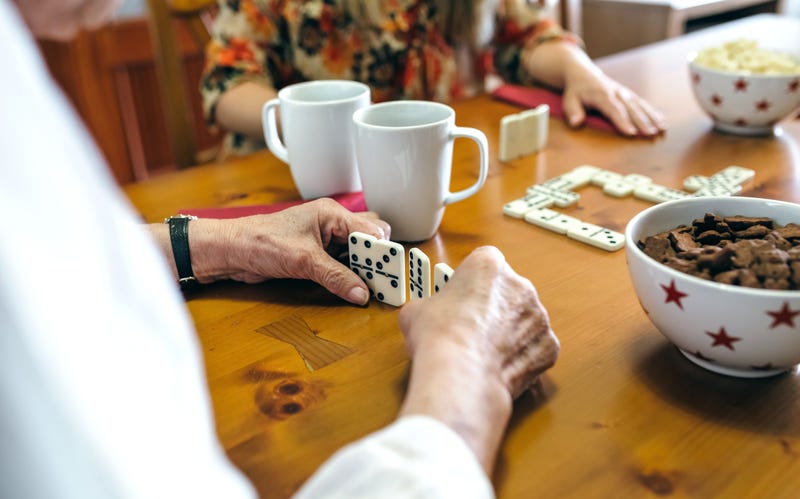 Senior mother and daughter playing dominos