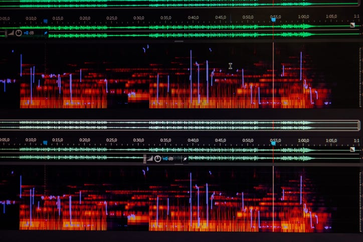 Close-up of audio editing timeline while playing sound on a spectrum analyzer 