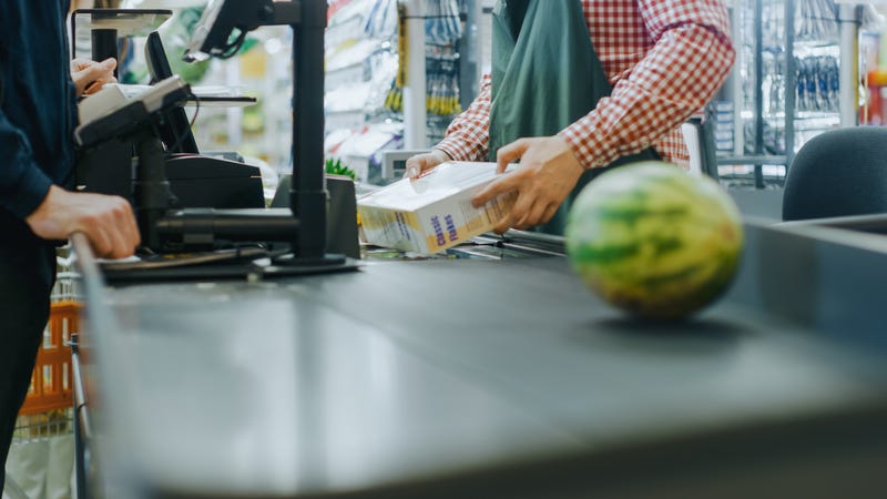 Checkout Counter Hands of the Cashier Scans Groceries