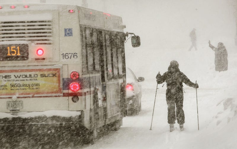 A city bus passes a skier on Michigan Avenue during a snowstorm February 2, 2011 in Chicago, Illinois. A blizzard dumped more than 20 inches of snow overnight in Chicago, making it the third largest snowfall recorded in the city's history.