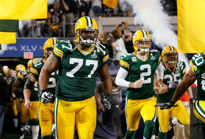 ARLINGTON, TX - FEBRUARY 06: Cullen Jenkins #77 and Mason Crosby #2 of the Green Bay Packers run onto the field prior to Super Bowl XLV at Cowboys Stadium on February 6, 2011 in Arlington, Texas. 