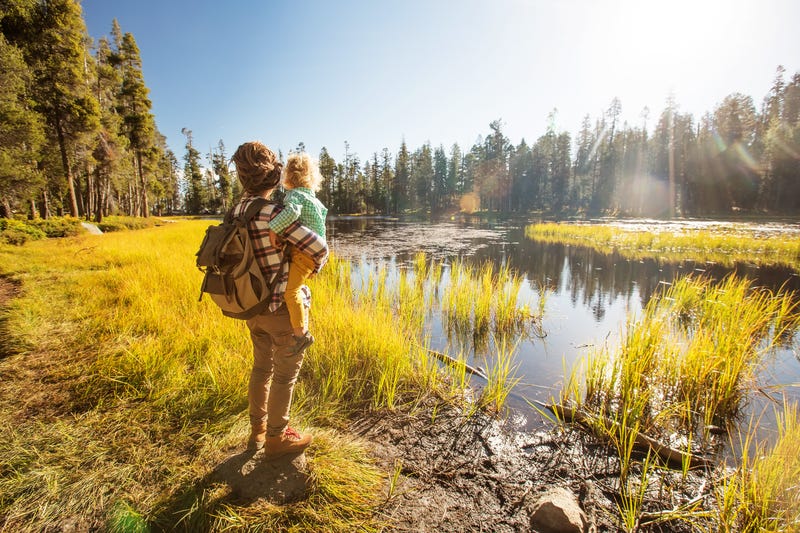 Woman holding baby while hiking
