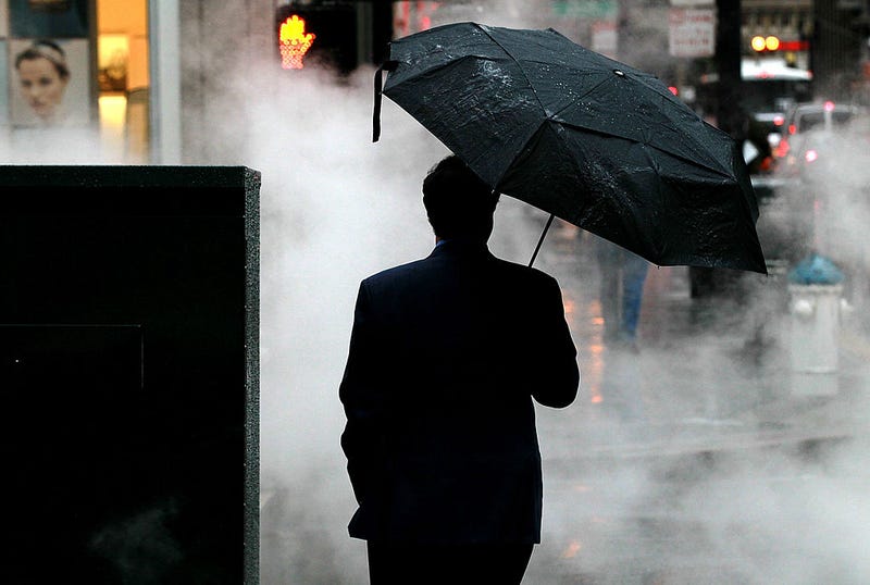 A pedestrian holds an umbrella as he waits to cross the street in on February 17, 2011 in San Francisco, California.