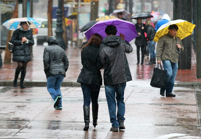 Pedestrians carry umbrellas as they walk down Market Street on February 17, 2011 in San Francisco, California.