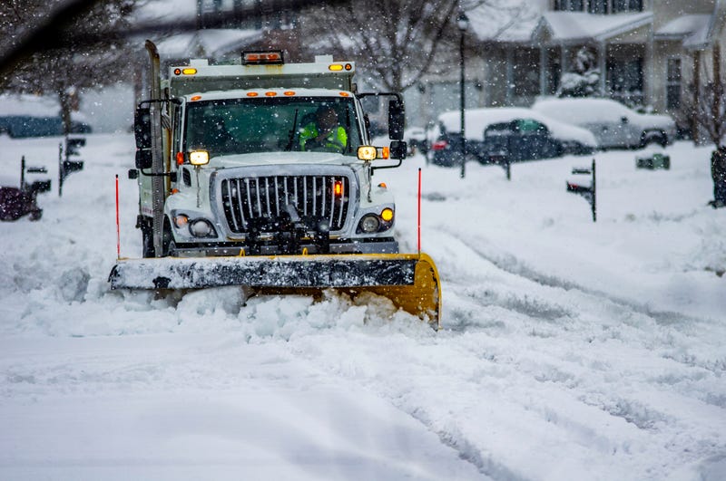 Snowplow moving snow on a residential road. 