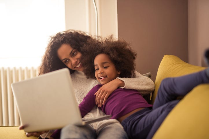 mom and daughter using  laptop