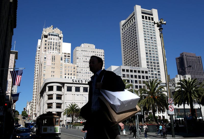 A pedestrian carries shopping bags as he walks through Union Square on February 22, 2011 in San Francisco, California.