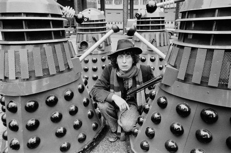 English actor Tom Baker as the 'Doctor' with Daleks on the set of British television series 'Doctor Who', UK, 5th March 1975