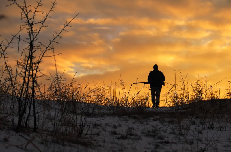 Shotgun hunter at sunrise