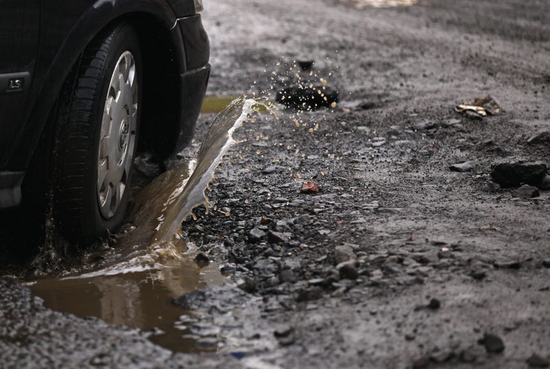car hitting pothole