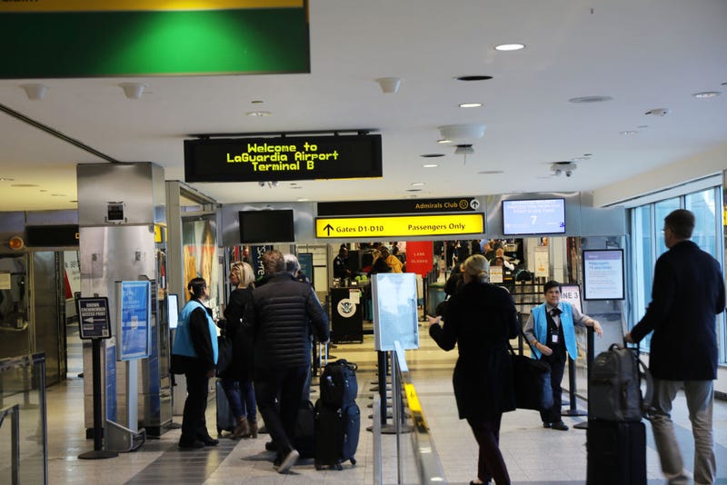 People walk through LaGuardia Airport on on January 25, 2019.