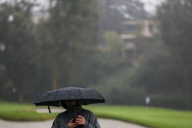 A man walks in the rain.