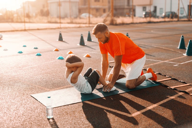 Kid working with personal trainer
