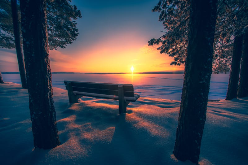 A bench and winter sunset